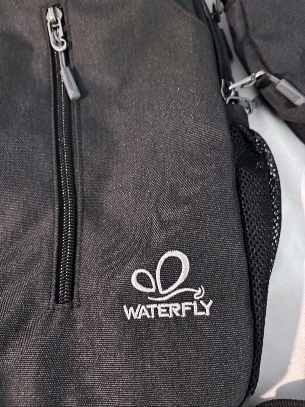 Waterfly Black Sling Backpack Crossbody Travel Bag Side Elastic Mesh Pockets